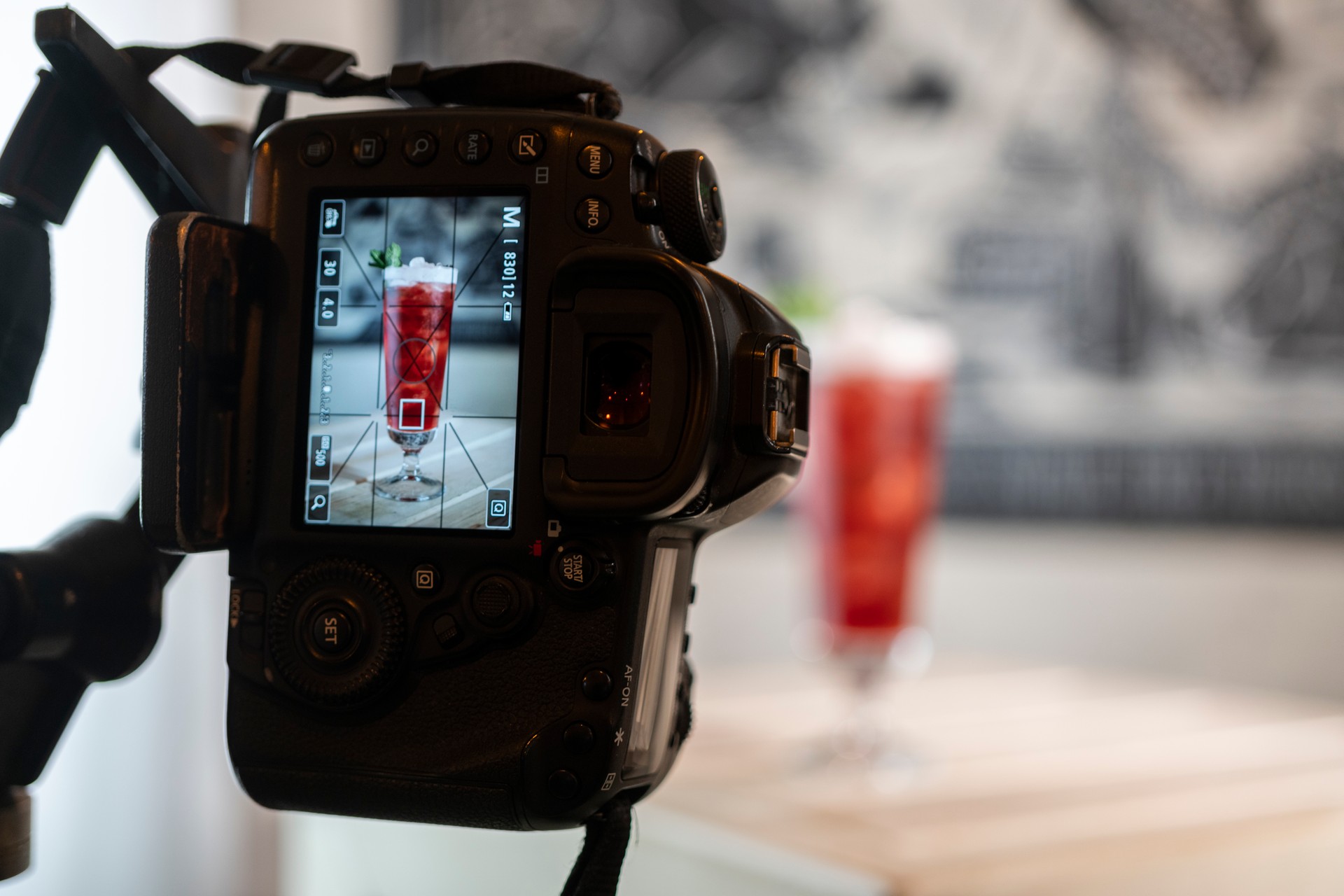 Photographing Cold refreshing red lagoon cocktail with ice and orange Aperol